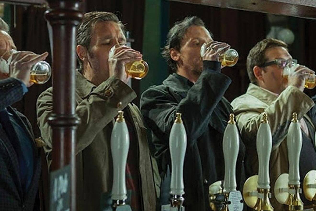 Men drinking at a bar in the UK