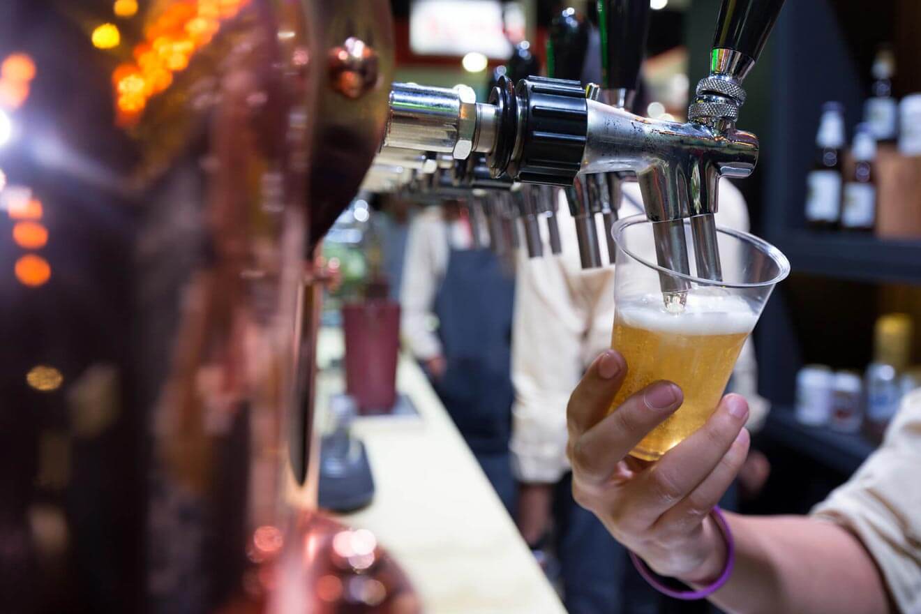 Man pouring beer in the UK